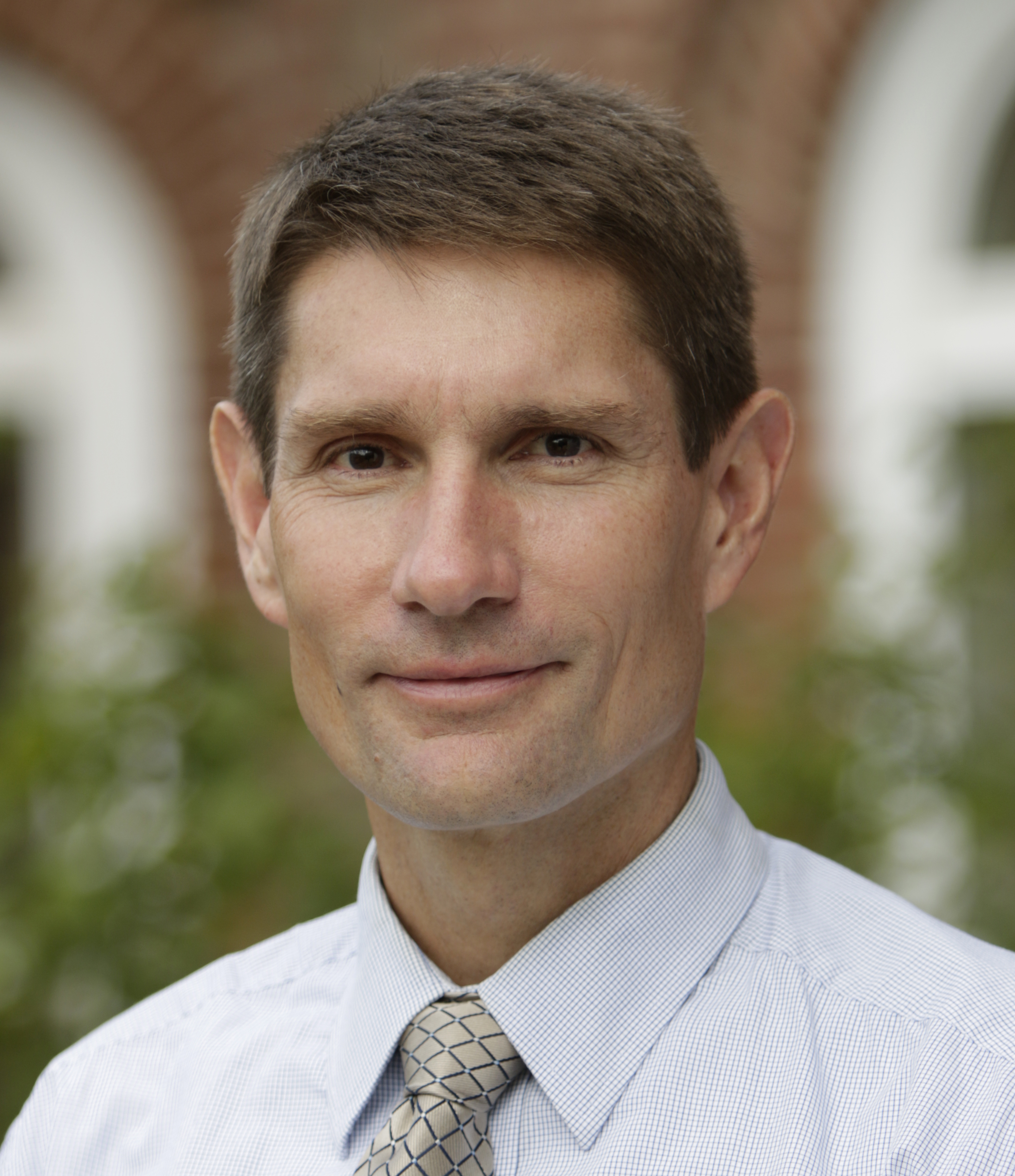 Dr. Richard Isnor, AVP Research & Graduate Studies Man wearing shirt and tie smiling
