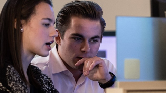 Students collaborating on a computer project as part of their business administration degree in Enterprise Systems.