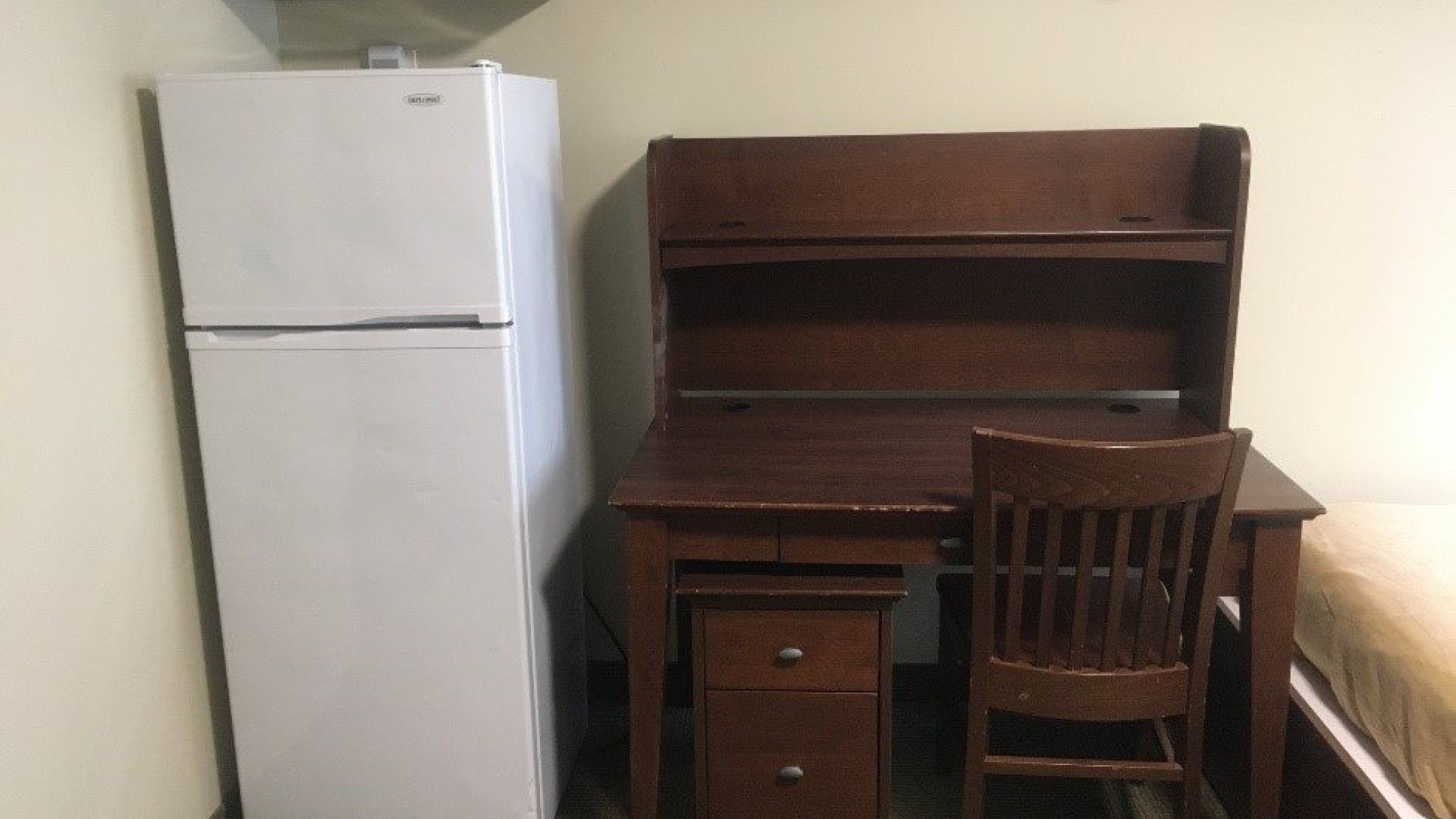 Fridge and desk located in a double room