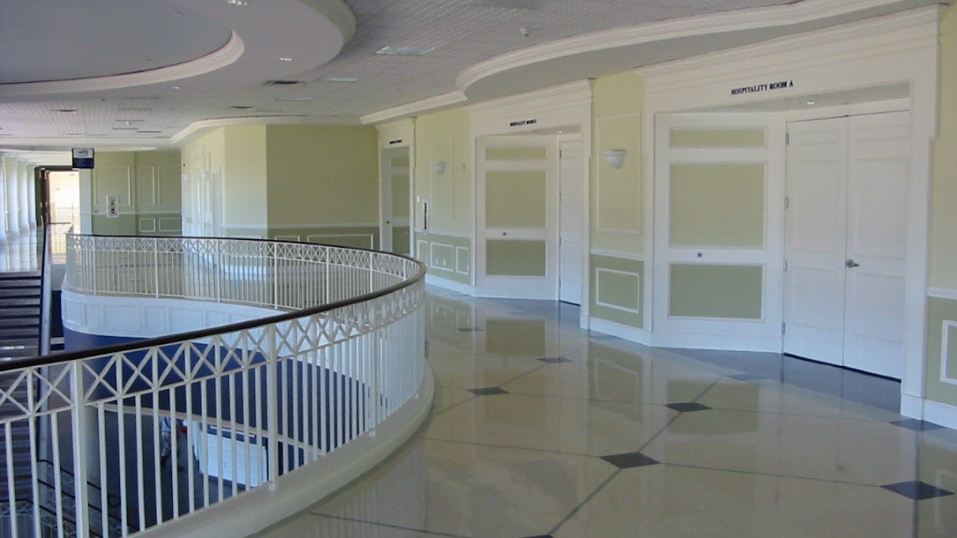 An empty room with a spiral staircase and tiled floor