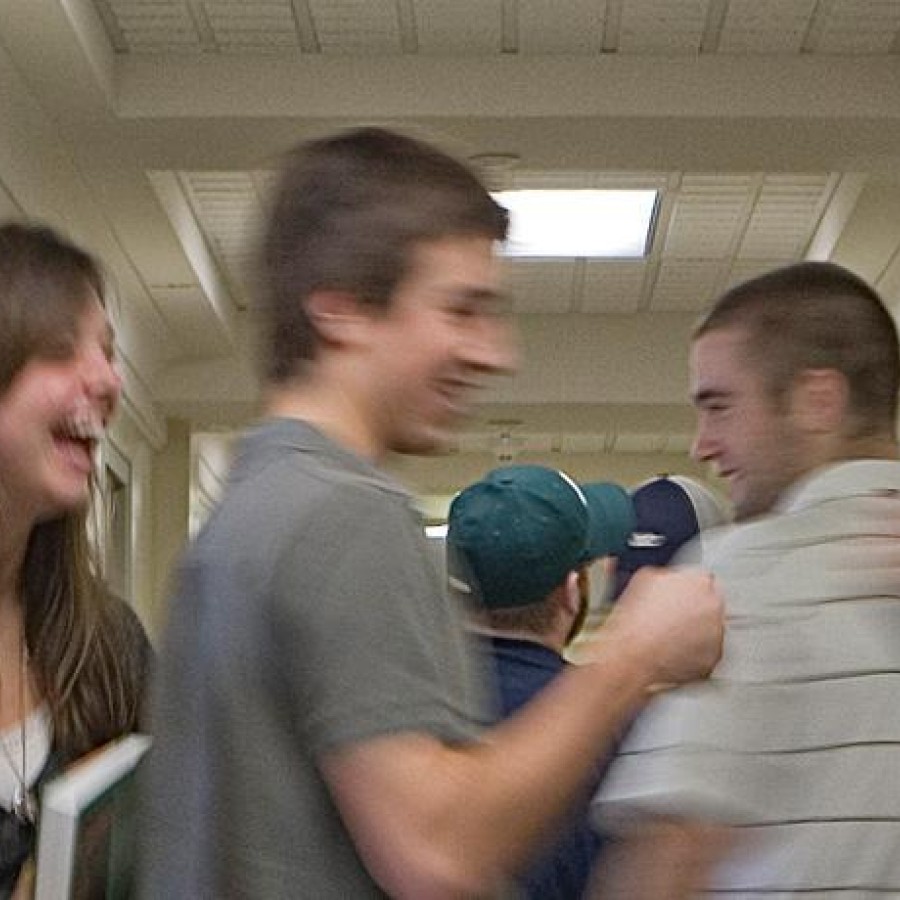 Students joking around in the school hallway