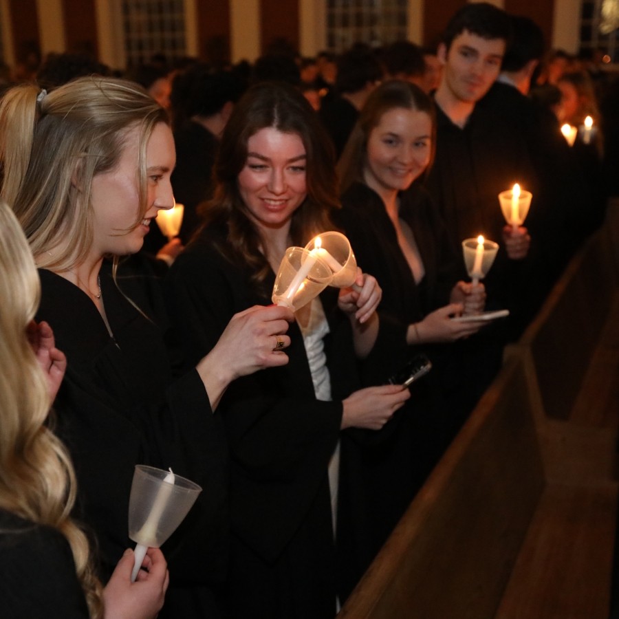 Close up of students lighting candles during the Xaverian Farewell. 