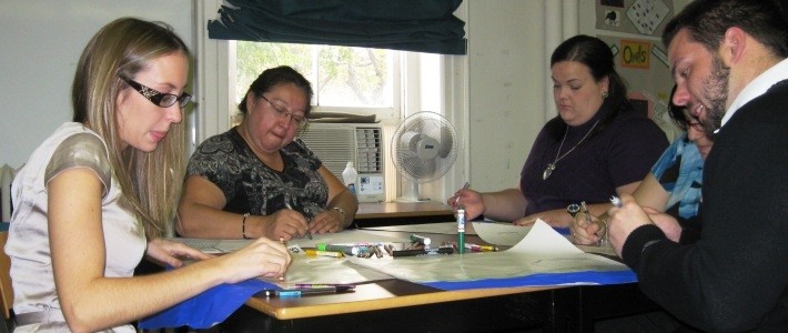 Caption: a group of people sitting around a table
