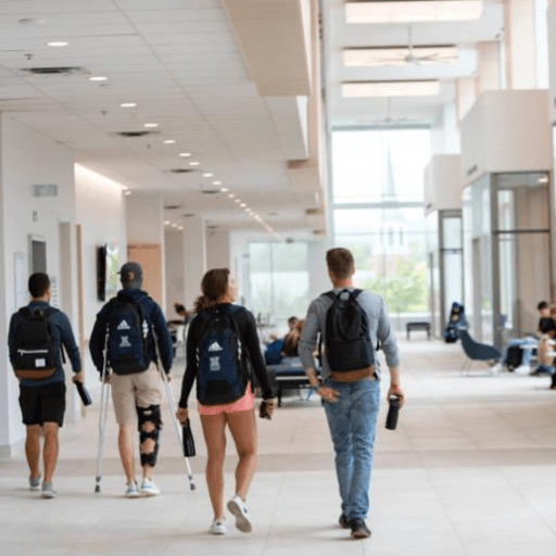 2 Students Walking Together in the Bryan Murloney Institute of Govt. Building