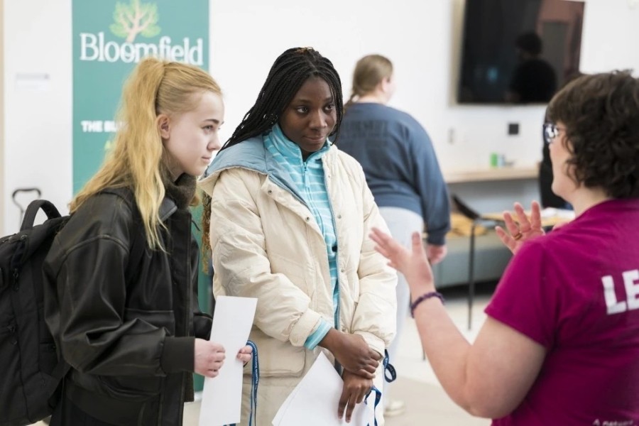 students talking to a department at the on campus job fair