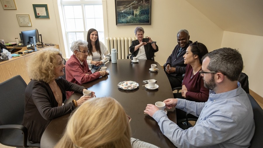 Group of people sitting around a table talking