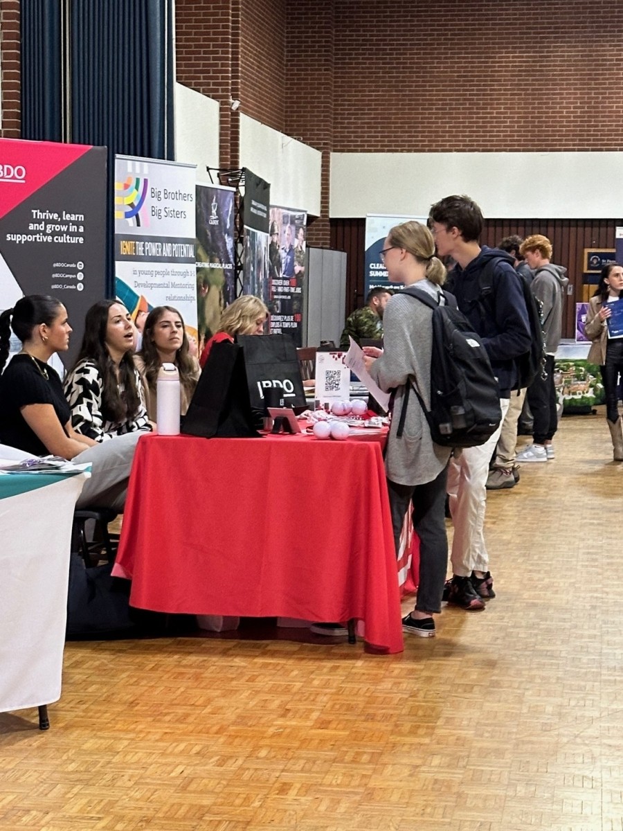 students talking to exhibitors
