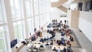 View of the main hall of the building from above, people listening to a speech